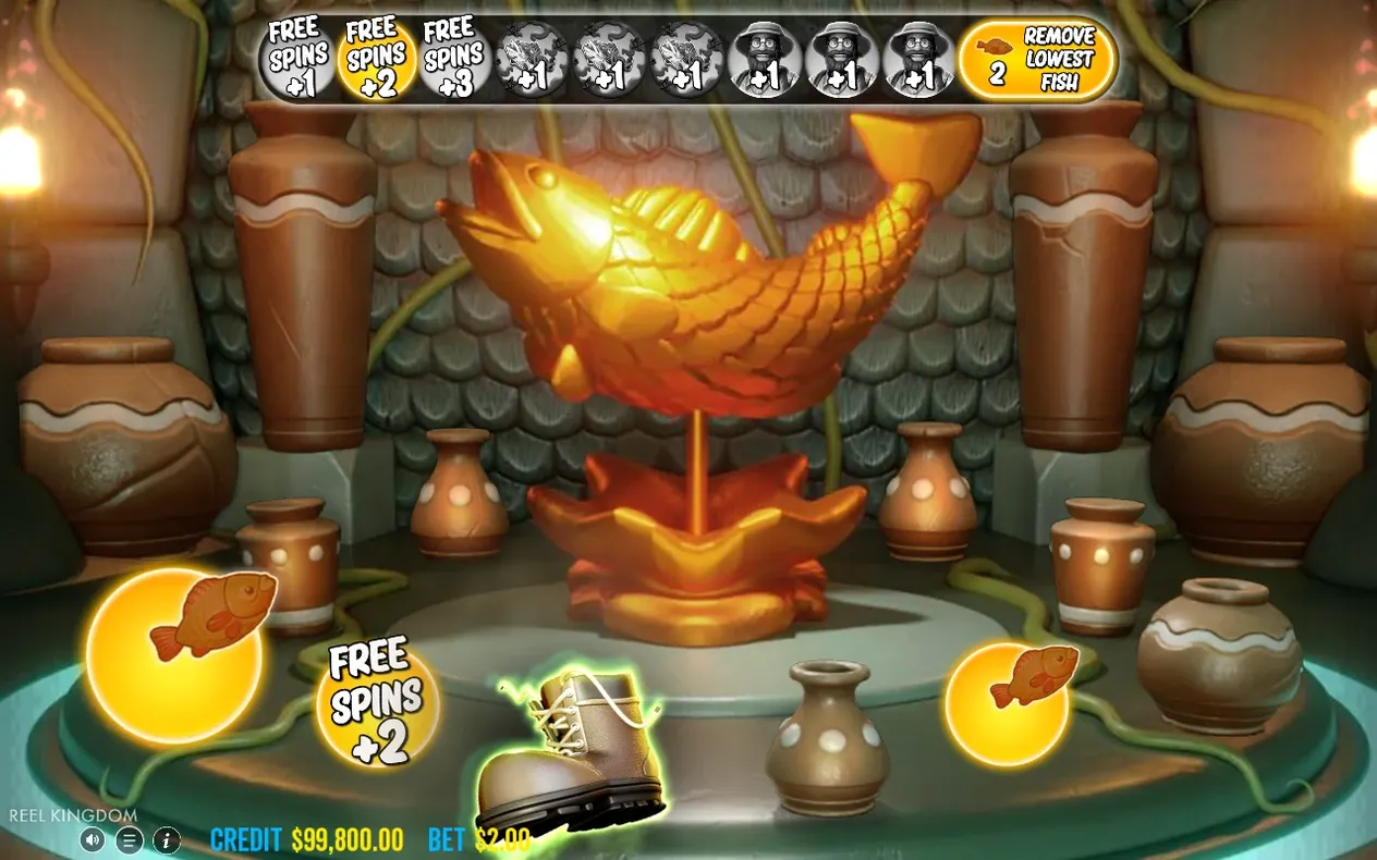 Golden fish statue scene shows Free Spins +2 lit gold and Remove Lowest Fish counter at 2.